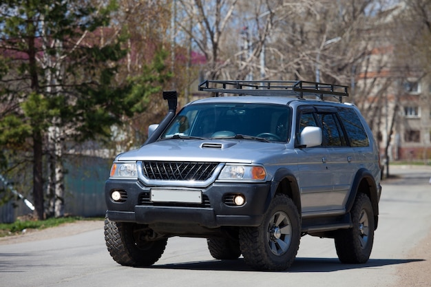 Tuned japanese suv in the street in spring