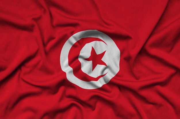 Tunisia flag  is depicted on a sports cloth fabric with many folds. 