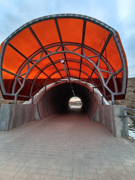 A tunnel that has a red canopy over it