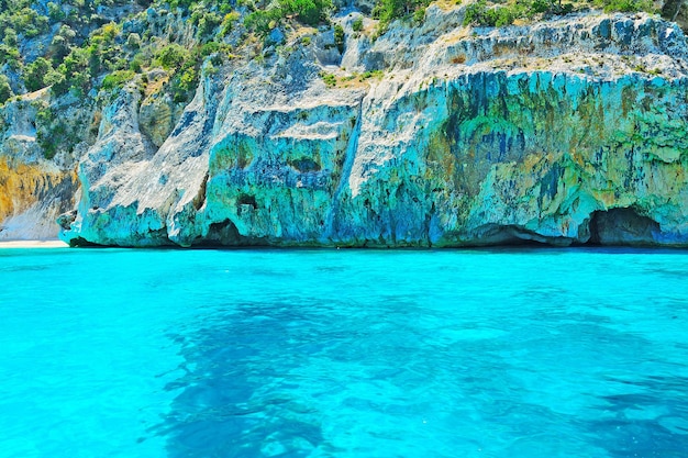 Tuquoise water and grey rocks in Orosei Gulf shoreline