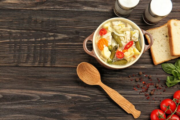 Фото Супница с супом из индейки на деревянном столе