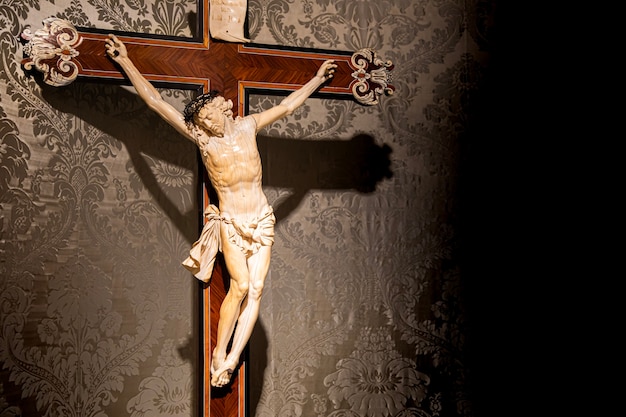 TURIN, ITALY - CIRCA MAY 2021: old crucifix made of wood and ivory (1750). Jesus Christ symbol of resurrection and life after the death.