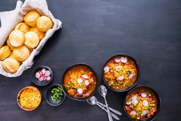 Turkey chili garnished with fresh radishes, green onions and cheddar cheese.