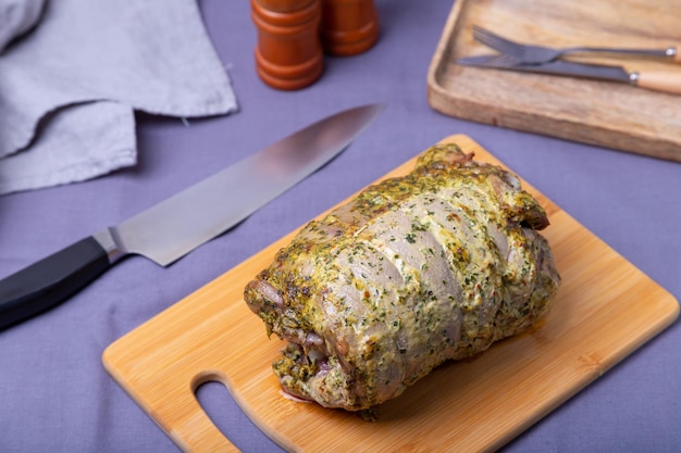 Turkey thigh on the bone baked with mustard parsley spices and chili on a wooden board Closeup