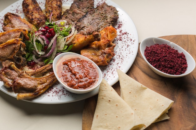 Turkish and Arabic Traditional Kebab plate. Fresh cooked meat in restaurant.