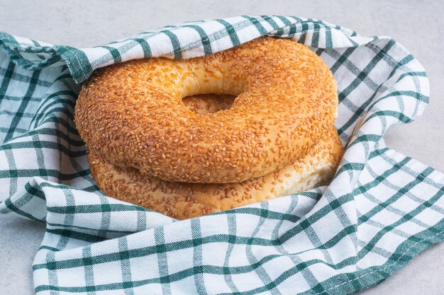 Turkish bagels on a tea towel, on the marble background.