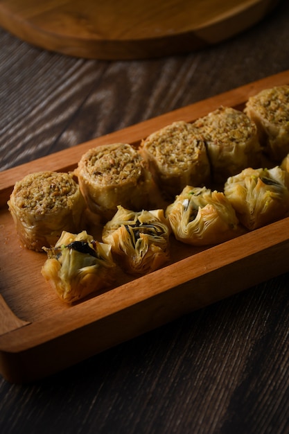 Turkish Baklava sweet pastry on wooden tray