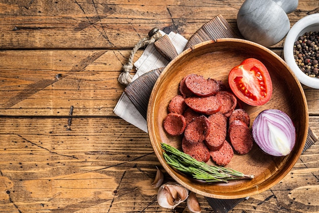 Turkish breakfast with Fried sausage sucuk on a rustic plate Wooden background Top view Copy space