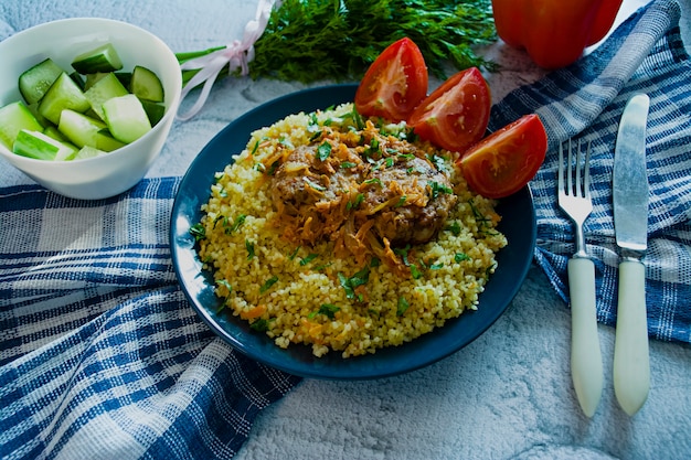 Turkish bulgur pilaf with meatballs and greens. 