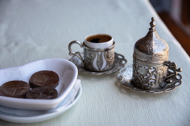 Turkish coffee in a beautiful traditional cup with a stylish lid Beautiful serving of coffee in a Turkish cafe