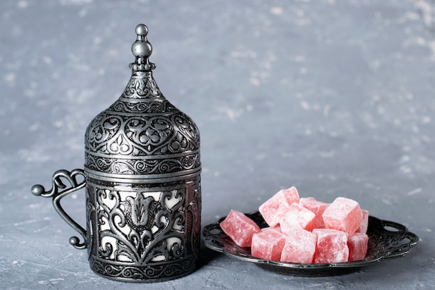 Turkish coffee. Oriental tableware with a pattern. Coffee beans, Turkish delight