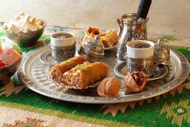 Turkish coffee served with turkish delight on metal tray