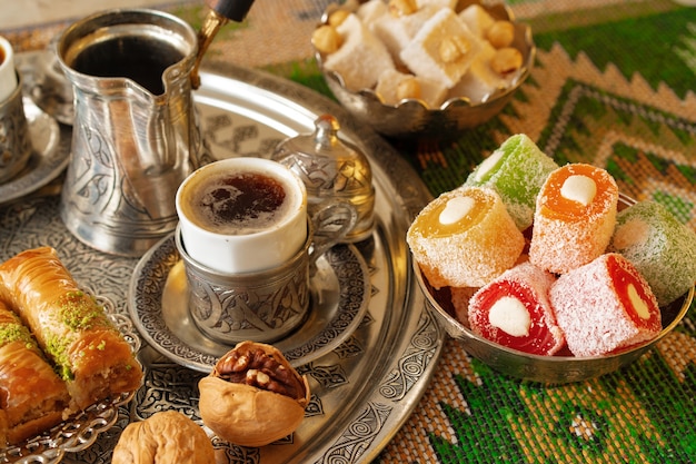 Turkish coffee served with turkish delight on metal tray