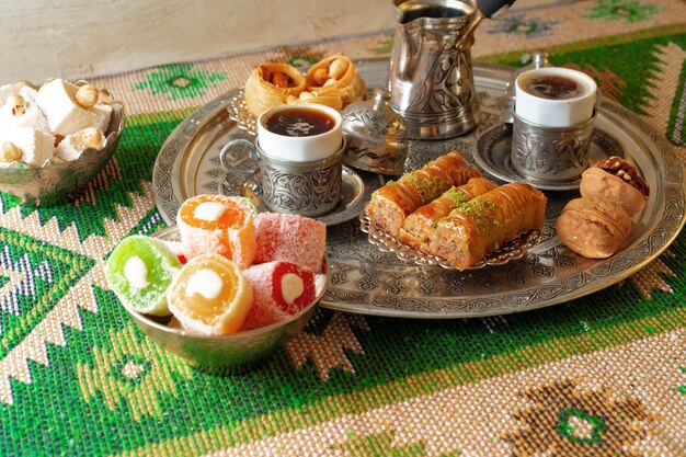 Turkish coffee served with turkish delight on metal tray