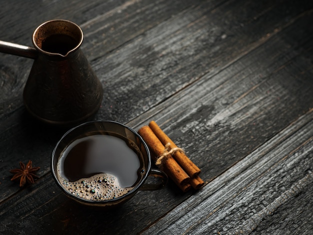 Turkish coffee in a Turk on a wooden table