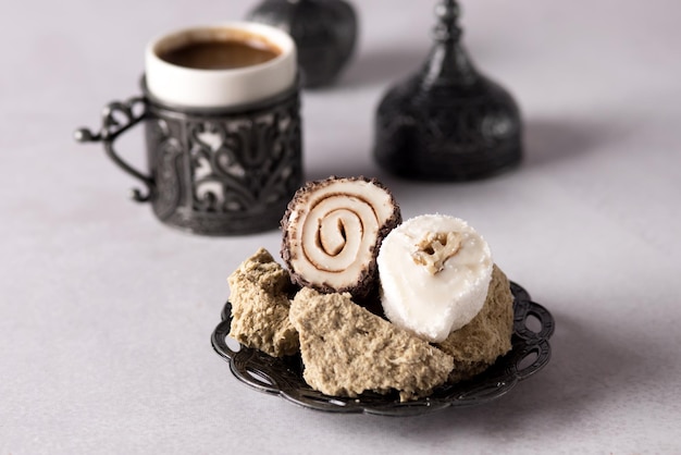 Turkish Coffee and Turkish Delight with Traditional Embossed Metal Plate and Cup Gray background