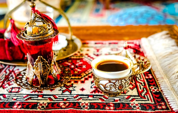 Turkish coffee with delight and traditional copper serving set on retro copper tray