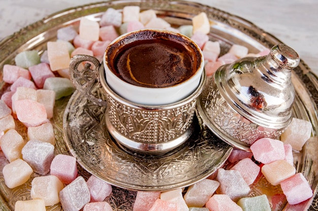 Turkish coffee with delight and traditional copper serving
set