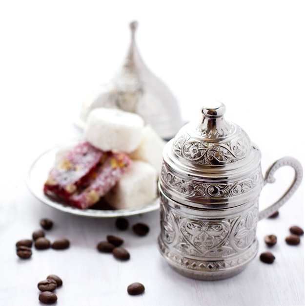 Turkish coffee with traditional turkish sweets in silver mug