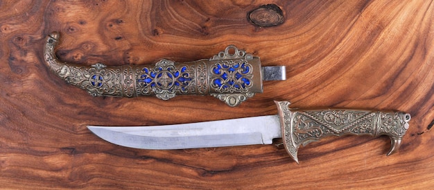 Turkish dagger on wooden background