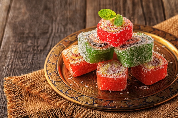 Turkish delight on dark wooden background