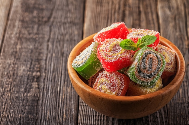 Turkish delight on a dark wooden bowl