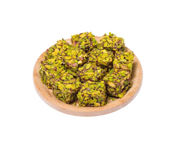 Turkish delight sweets on a wooden stand on a white background