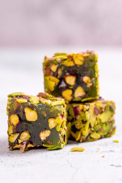 Turkish Delight with Pistachio on a stone background Traditional Turkish delicacies Turkish Delight with Apple Flavored Pistachio close up