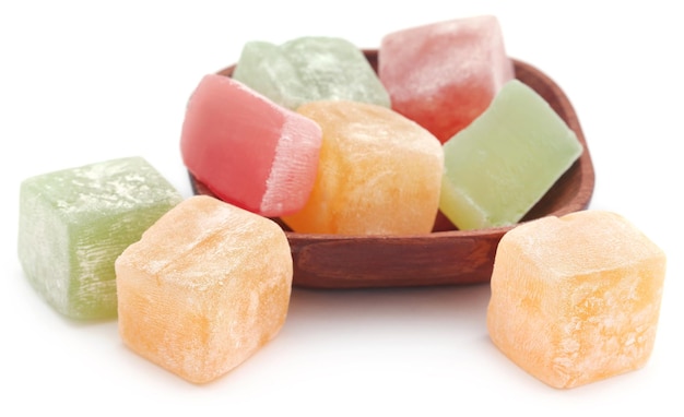 Turkish delight in a woden bowl over white background