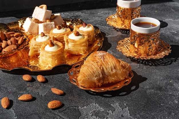 Turkish dessert baklava with a cup of coffee on black background