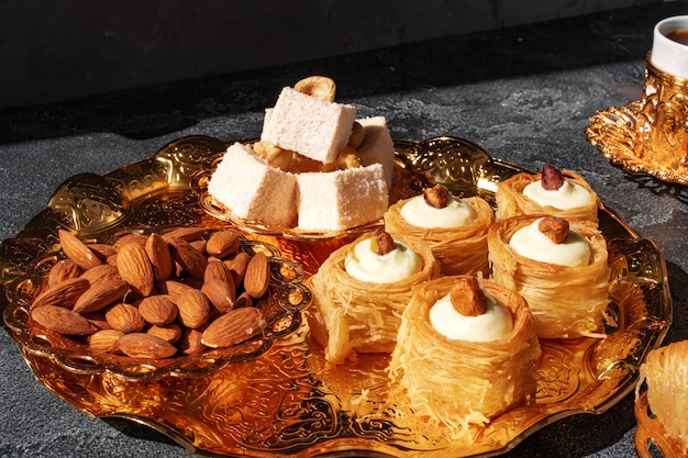 Turkish dessert baklava with a cup of coffee on black background