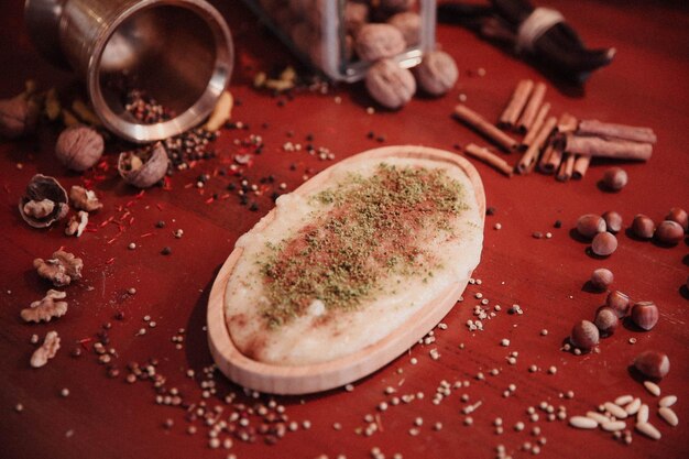 Turkish dessert kunefe, kunafa, kadayif with pistachio powder and cheese hot eaten a sweet
