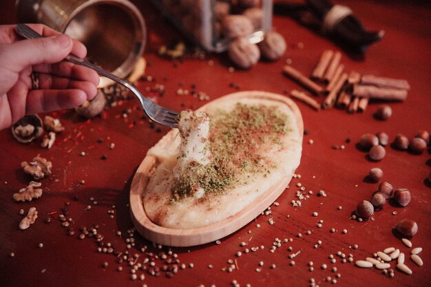 Turkish dessert kunefe kunafa kadayif with pistachio powder and cheese hot eaten a sweet