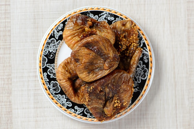 Turkish fig in plate on white wood