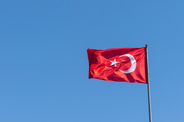 Turkish flag on the background of a clear empty sky