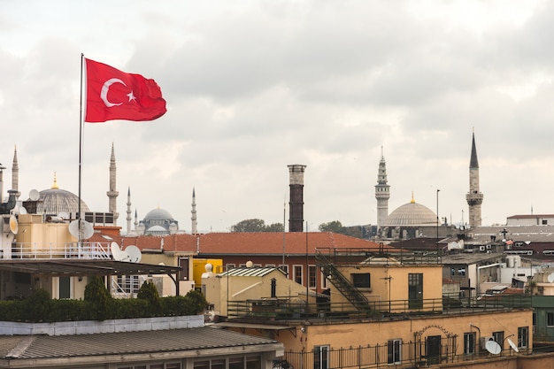 Turkish flag and istanbul rooftops view with mosque