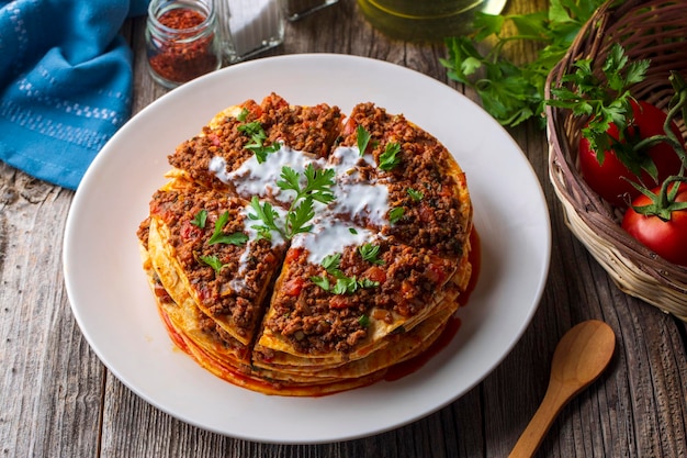 Turkish food kayseri yaglama with minced meat yogurt and tomato paste