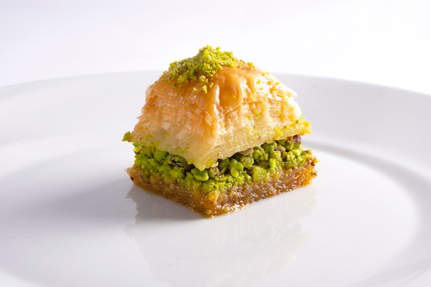 Turkish Greek pistachio baklavas on white solid plate