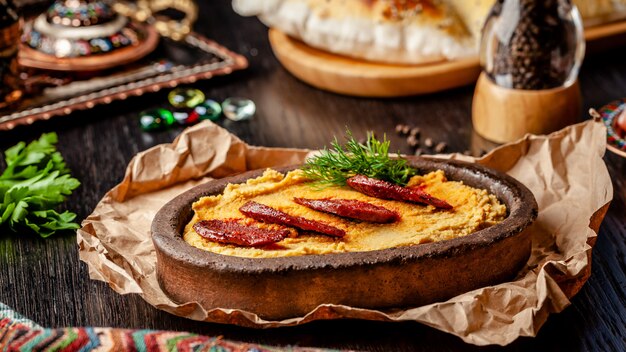 Turkish Hummus with salami sausage.