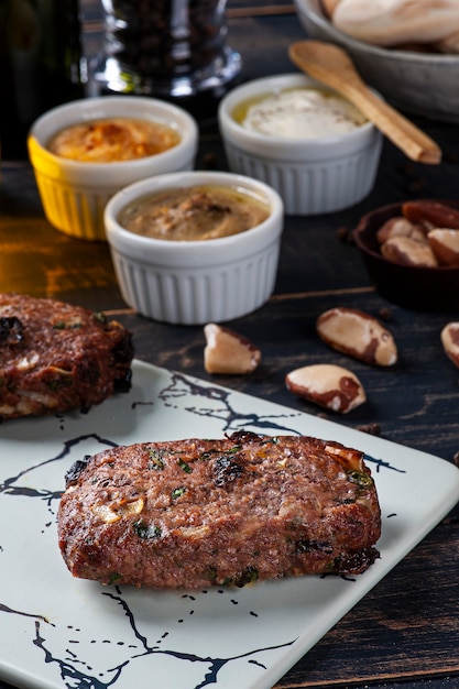 Turkish kafta, accompanied by curd, hummus and babaganoush.