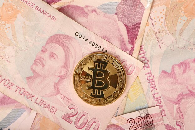 Turkish lira banknotes and bitcoin coin