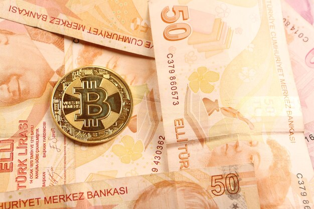 Turkish lira banknotes and bitcoin coin