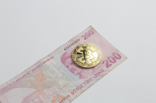 Turkish lira banknotes and bitcoin coin