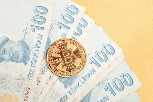 Turkish lira banknotes and bitcoin coin