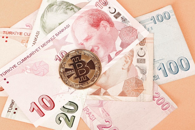 Turkish lira banknotes and bitcoin coin