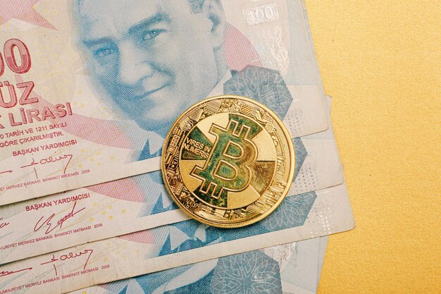 Turkish lira banknotes and bitcoin coin