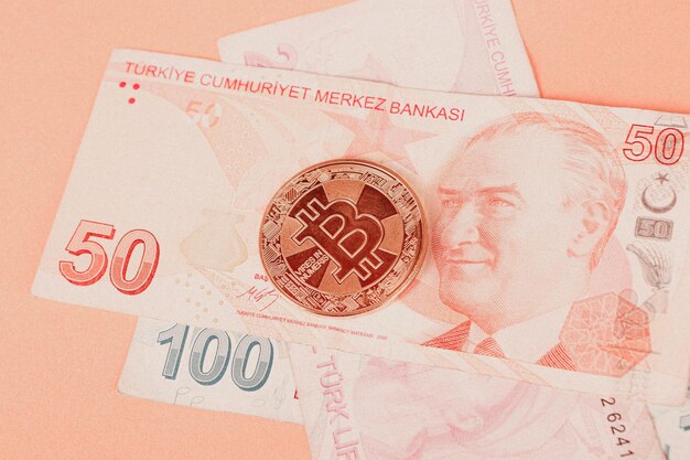 Turkish lira banknotes and bitcoin coin