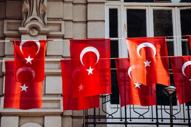 Turkish national flags with white star and moon in sky