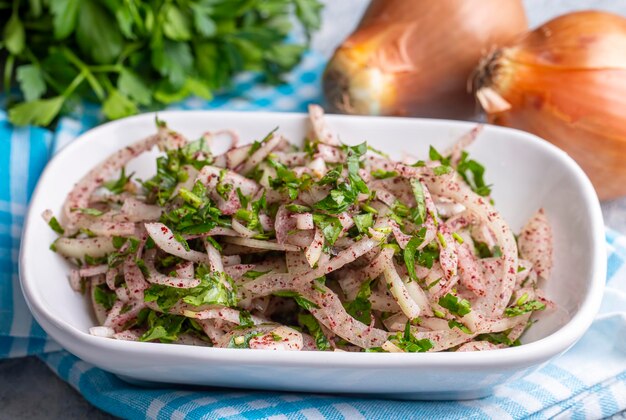 Turkish onion salad is served with kebabs accompanied by lemon and parsley