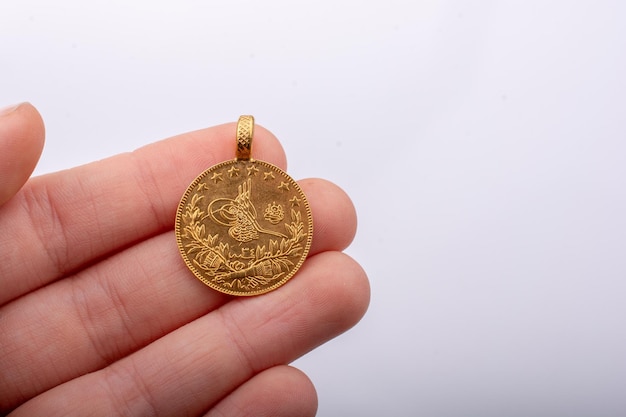 Turkish Ottoman style gold coin in hand